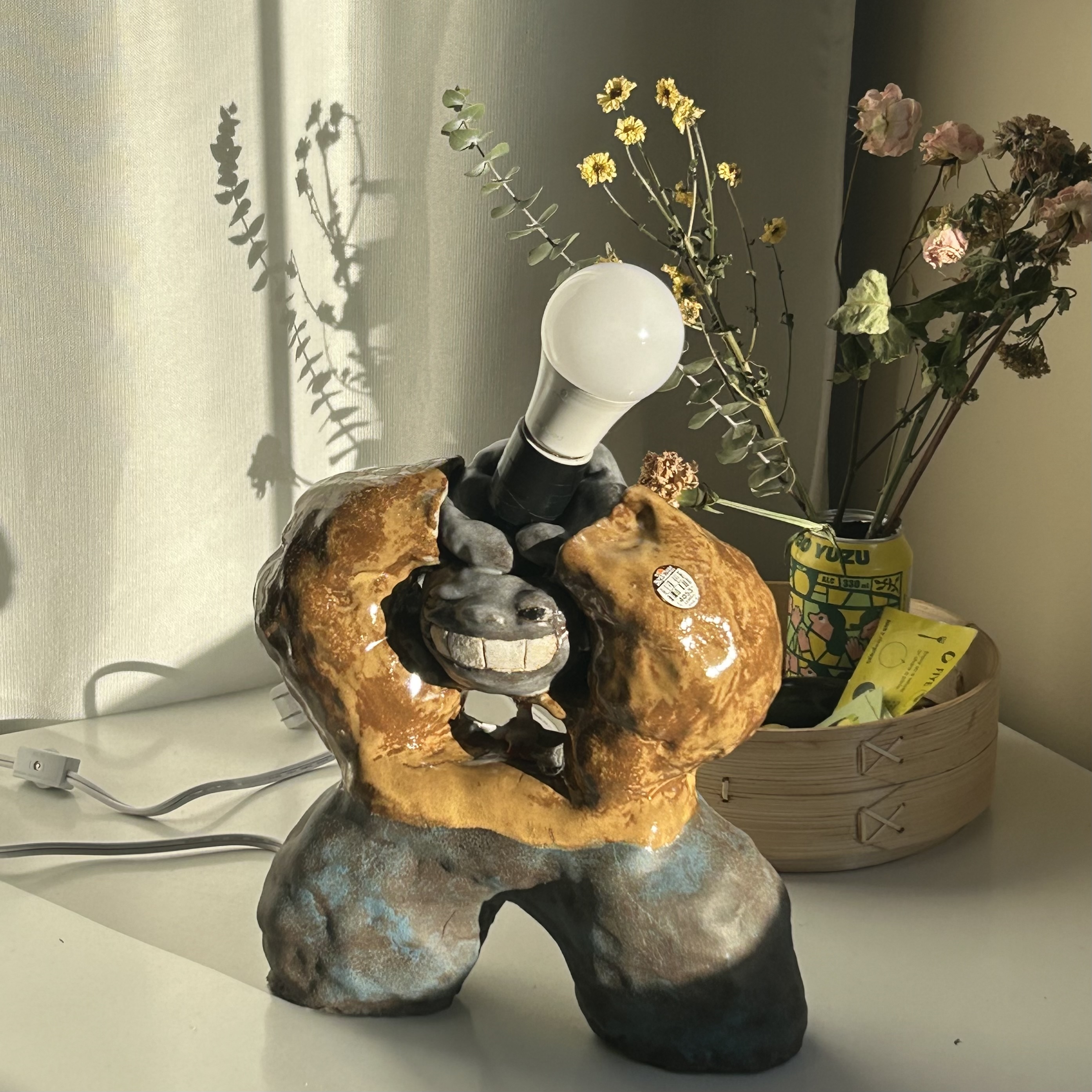 a person shaped lamp made of out ceramic